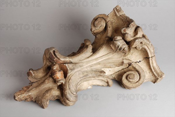 Carved wooden console from the façade of house, console building element carvings sculpture visual material wood gypsum paint