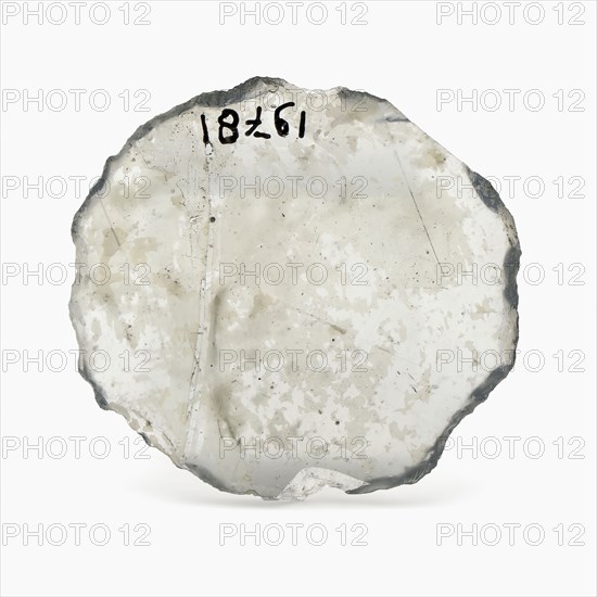 Oval glass disk of thin window glass, disc artifact soil find glass, cast cut cut Oval slice thin window glass