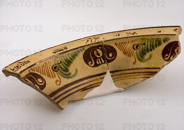 Three fragments of yellow dish, with brown and green décor of lines and rosettes, dated, dish crockery holder soil find ceramic