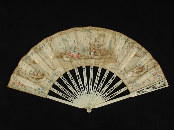 Folding fan with carved ivory frame and multicolored painted parchment leaf with rococo motifs and pastoral scene, folding fan