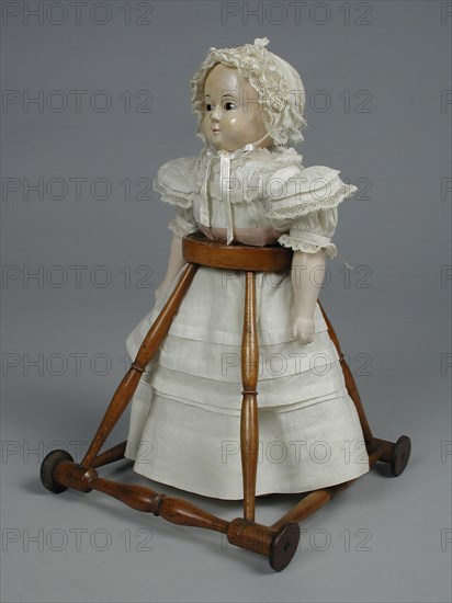 Paper mâché, hardened lower legs, forearms and head, dressed in four layers of white cotton dresses and cap, doll model dolls