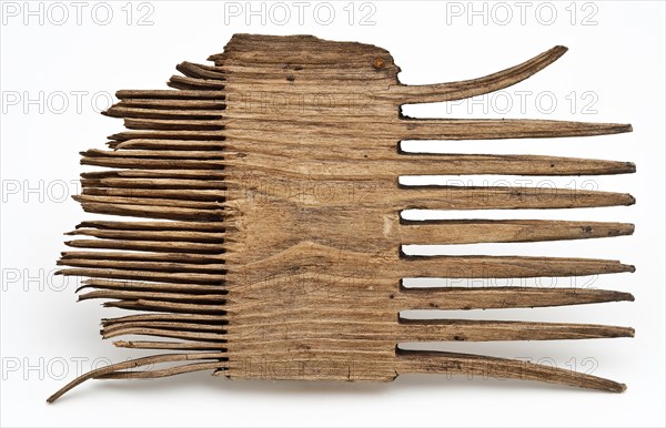 Wooden comb with coarse teeth on one side and fine teeth on the other side, comb soil finds timber, sawn Fragment wooden comb
