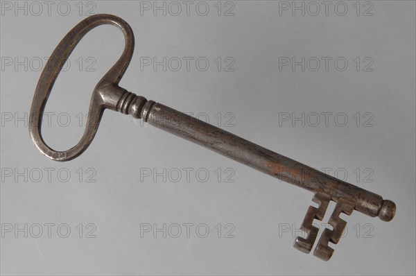 Iron key with elongated eye, solid key handle and cruciform beards in beard, key iron commodity founding iron, hand-forged key