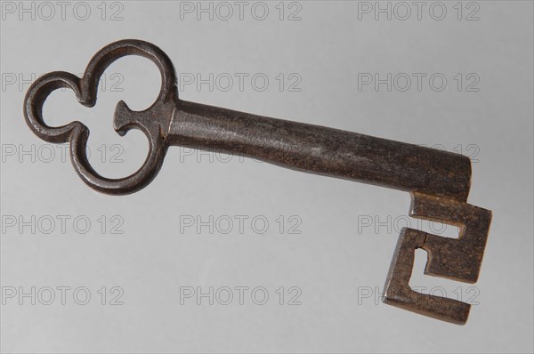 Iron key with cloverleaf-shaped eye, hollow key handle and cruciform beards in beard, key iron iron, hand forged Key