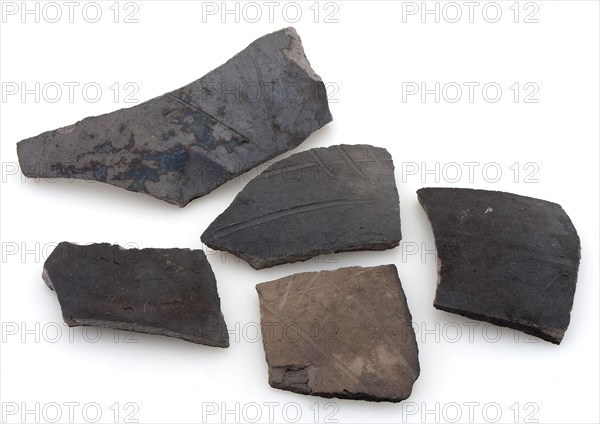 Fragments of cooking pots, dark earthenware, decorated with incised lines, cooking pot crockery holder kitchen utensils fragment
