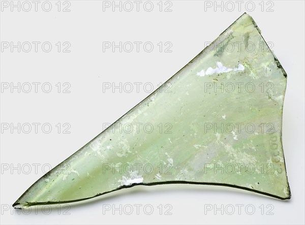 Fragment of window pane, glass soil found glass, hand-blown Fragment of window pane in clear green glass Edge curved up