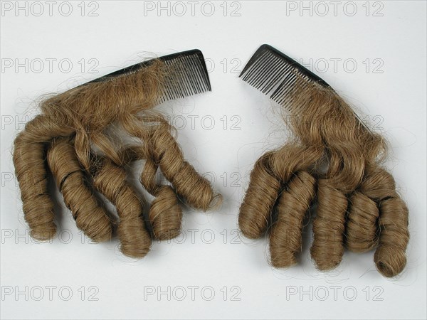 Two hairpieces with pipe shavings on curved black plastic Comb, hairpiece hair comb hair accessory hair turtle? plastic