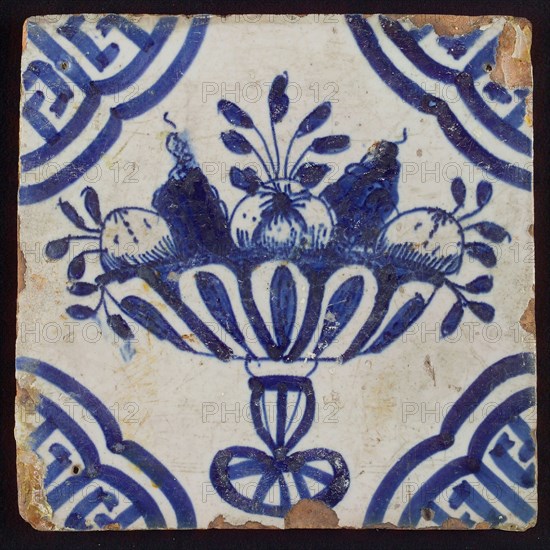 White tile with blue fruit bowl on stand, apples and grapes; corner pattern meander angle, wall tile tile material ceramics