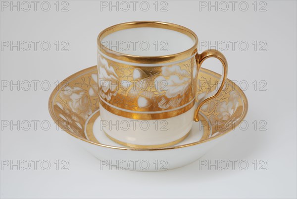 White cup and saucer with gold colored band with acorn and leaf decoration, cup and saucer drinkware tableware holder coffee
