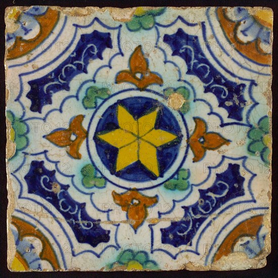 Ornament tile, blue, green, brown and yellow on white, central yellow star in circle, sgraffito surfaces, corner motif, quarter