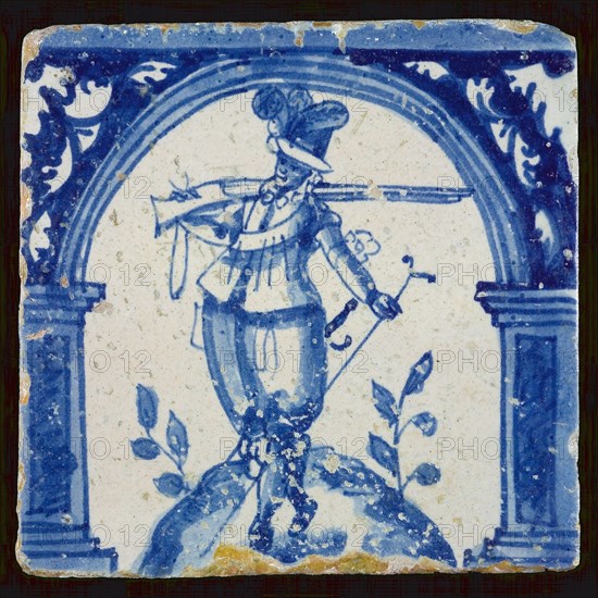 Figure tile, blue on white, warrior with rifle on the shoulder, wall tile tile sculpture ceramic earthenware glaze, baked 2x
