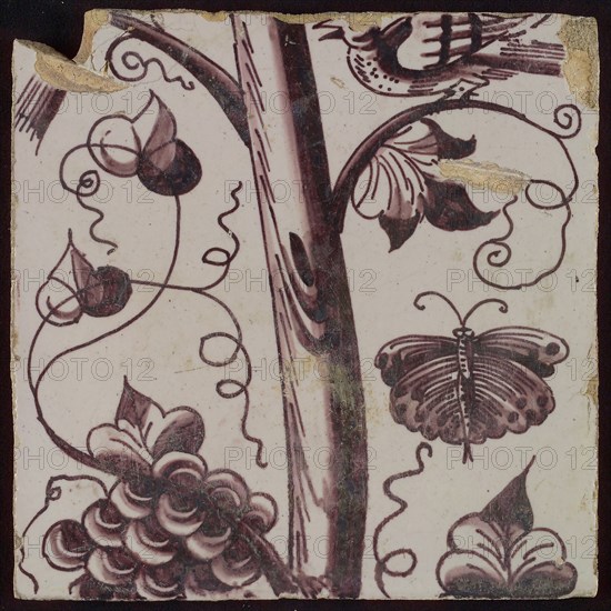 Tile of purple pilaster with tree trunk with curled twigs, leaves, bunches of grapes and surrounded by butterflies, bird, tile