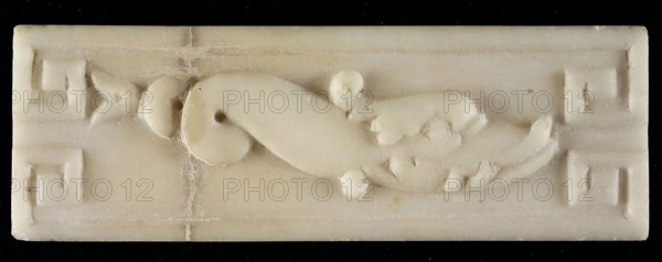 White marble relief, dolphin, with two curls in tail, meander-ornament in corners, relief marble stone, Rotterdam City Triangle