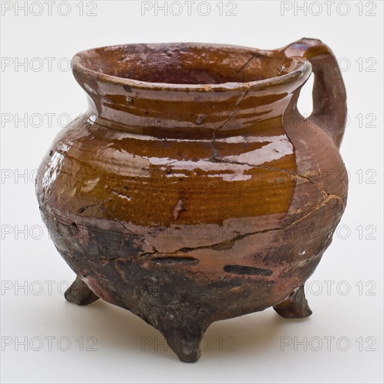 Pottery cooking pot, cooking jug with fine twisted arms on the shoulder, one sausage ear, on three legs, cooking pot tableware