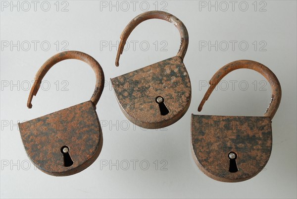 Three similar padlocks with matching keys, which belong to the storage handles of the oak coffin, padlock lock closing device
