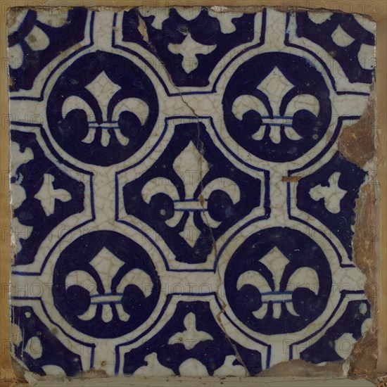 Two-tone tile, blue on white background, four circles with white French lily around central ornament with lily, wall tile