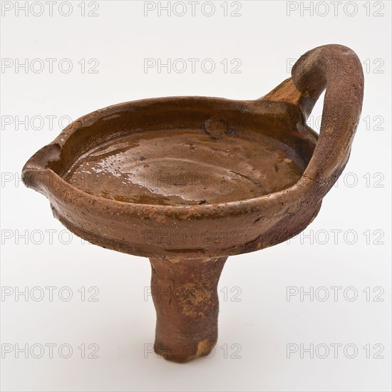 Fragment of earthenware oil lamp, dish with hanging ear and pouring clip on part trunk, oil lamp lamp lighting medium soil find