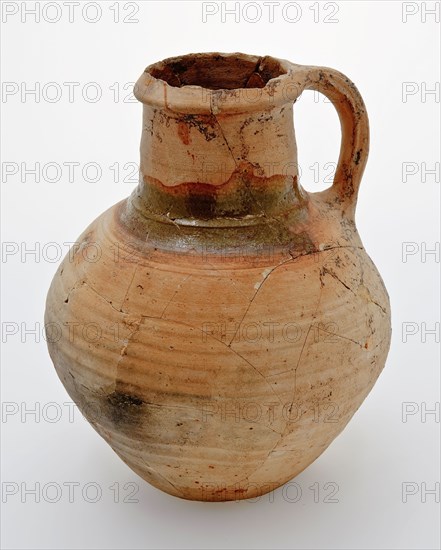 Pottery jug on lens bottom, yellowish shard, green lead glaze on the shoulder, jug crockery holder soil find ceramic earthenware
