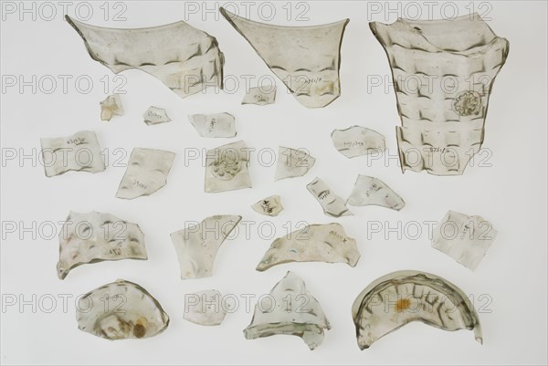 Fragments of soil, stand ring, wall and bramble decoration of waffle cup, beaker tableware holder fragment soil found glass