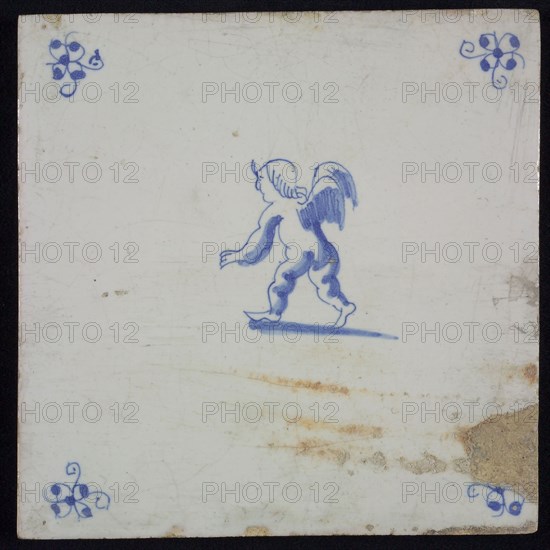 Figure tile with running angel or putto, blue decor on white ground, corner filling: spider, wall tile tile sculpture ceramic