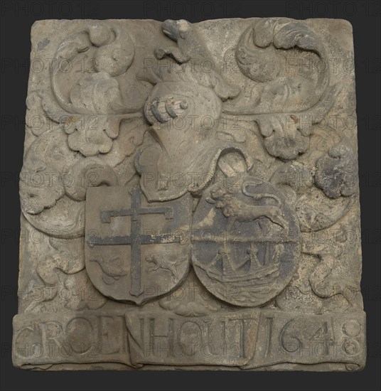 Facing brick with arms of the cheese buyer Adriaen Groenhout and Ermgaard Beaumont and caption Groenhout 1648, gable sculpture