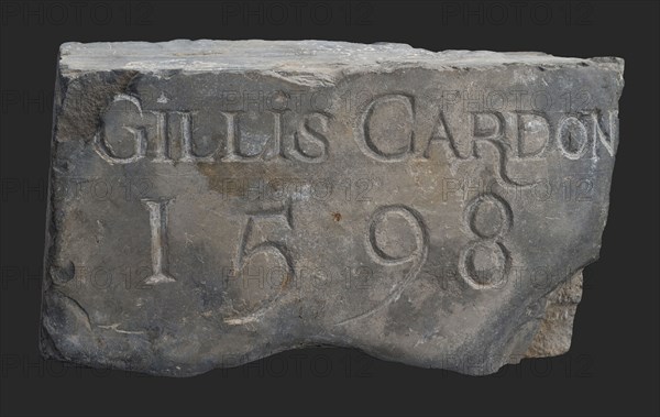 Stone with text Gillis Cardon 1598, tombstone? facing brick? building component? slate stone, chopped Rectangular text
