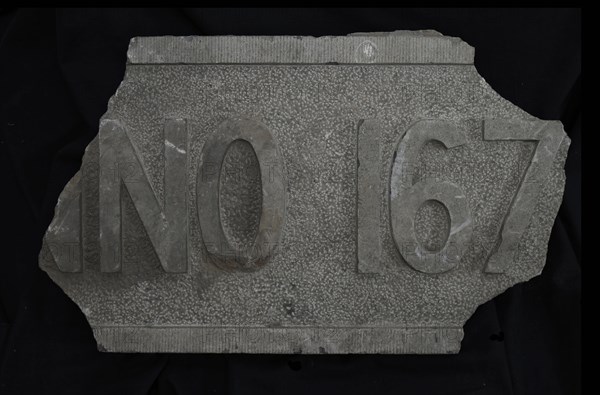 Fragment of facing brick with text ... NO 167 .., facing brick foundation stone building part stone, chopped rectangular frame