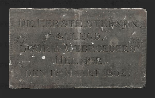 Facade stone with text THE FIRST STONE LOCATED BY THE BROTHERS HELMER DEN 17E MARCH 1862, facing brick first stone building part