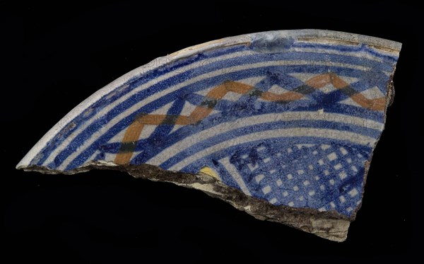 Fragment majolica dish, yellow, orange and blue on white, cross shape with shaded areas in between, dish plate crockery holder