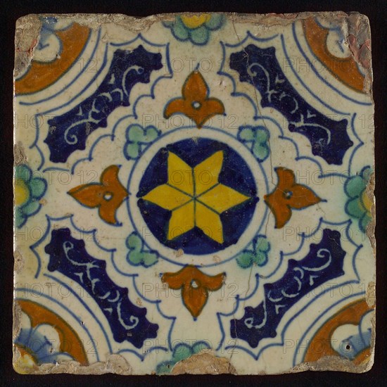 Tile, blue, green, brown and yellow on white, central yellow star in circle, sgraffito surfaces, corner motif, quarter rosette