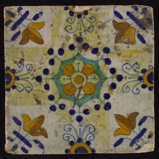 Tile, blue draft, yellow, green and orange on white, central flower within star shape, three-spot around, half rosette, corner