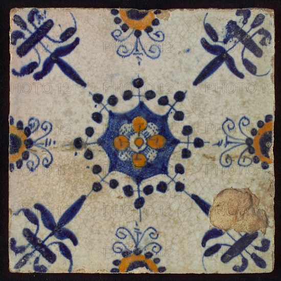 Tile, blue draft and orange on white, centrally flower within star shape, three-piece around, half rosette, corner pattern lily