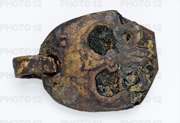 Strap or attachment plate of belt buckle, decorated with skull, belt tongue fitting clothing accessory clothing soil find copper