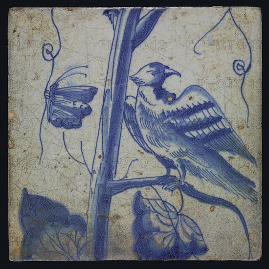 Blue tile with looking bird on grape leaf, butterfly, of chimney pilaster with 13 tiles, tree of bunches of grapes with birds
