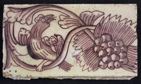 Rectangular edge tile in purple with serpentine decor of leafy tendril, toasted bird to the right, grape bunch, edge tile wall