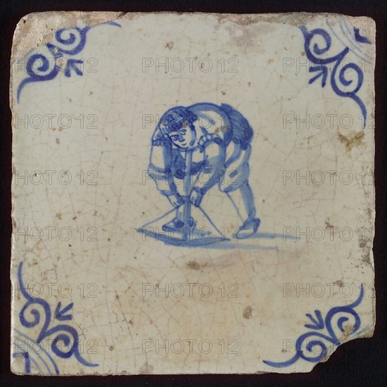 Scene tile, child's play, child with crossbow, corner pattern ox's head, wall tile tile sculpture ceramic earthenware glaze