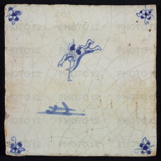 White tile with blue flying putto with wind instrument, corner motif spider, wall tile tile sculpture ceramic earthenware glaze