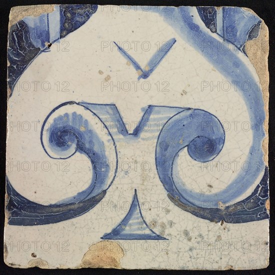 Tile of chimney pilaster, blue on white, part of capitals with stylized triangular navel and groin curls of caryatid, chimney