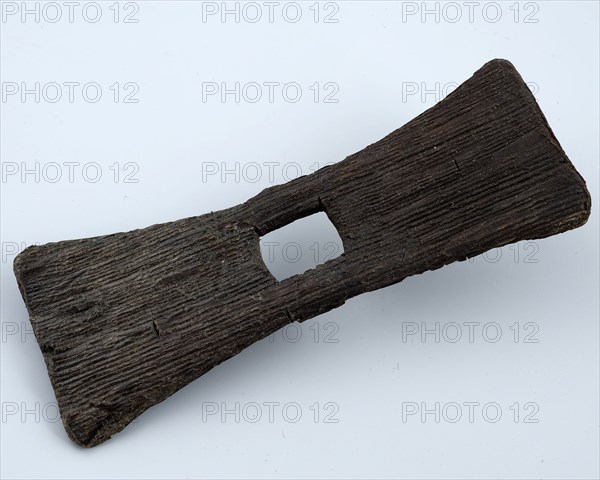 Butterfly-shaped wooden fragment with rectangular hole in the middle, artifact soil find wood, sawn inserted Wood fragment