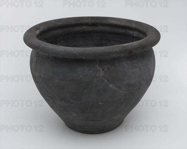 Black storage jar on standing surface, folded upper edge above constriction, storage jar pot holder soil find ceramic