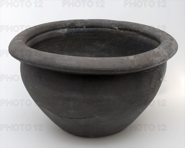 Black storage jar on standing surface, folded top edge above constriction, storage jar pot holder soil found ceramic earthenware