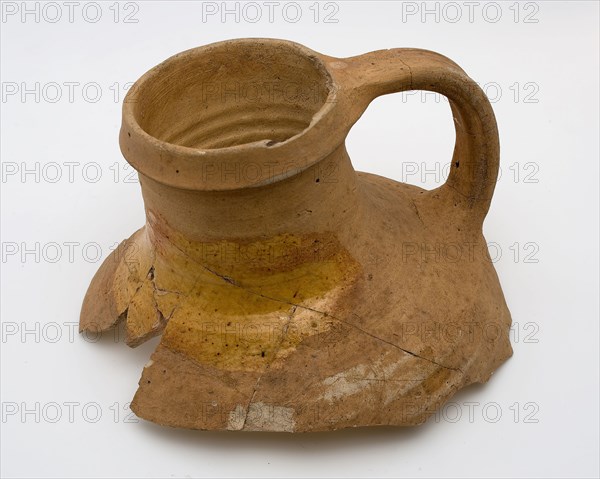 Neck of pottery jug from Andenne, yellow shard, lead glaze on the shoulder, kitchen utensils fragment soil found ceramic