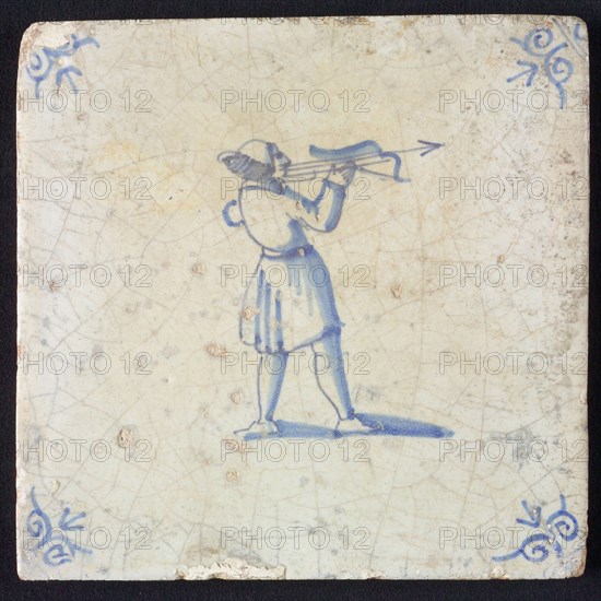 White tile with blue warrior with bow and arrow; corner pattern ox head, wall tile tile sculpture ceramic earthenware glaze
