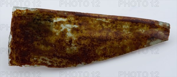 Green fragment of window glass with brown iridescence, window glass building material soil find glass, poured drawn Corner