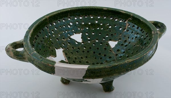 Green tapering colander on three legs, with two lying sausage ears, colander kitchen utensils earthenware ceramics earthenware
