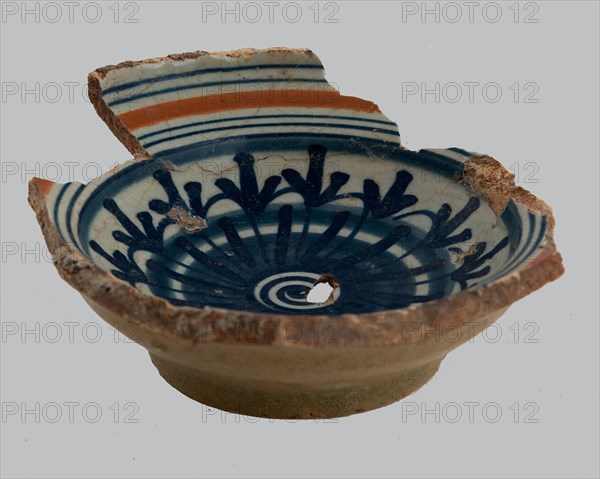 Fragment of majolica salt scale, rosette in the mirror, along the flag lines in orange and blue, salt barrel tableware holder