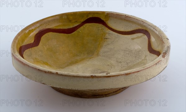 Small earthenware plate, yellow glazed with brown garland along the edge, plate crockery holder soil find ceramic earthenware