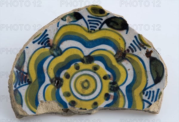 Mirror fragment of majolica dish with yellow and blue stylized flower decoration, plate dish crockery holder soil find ceramic