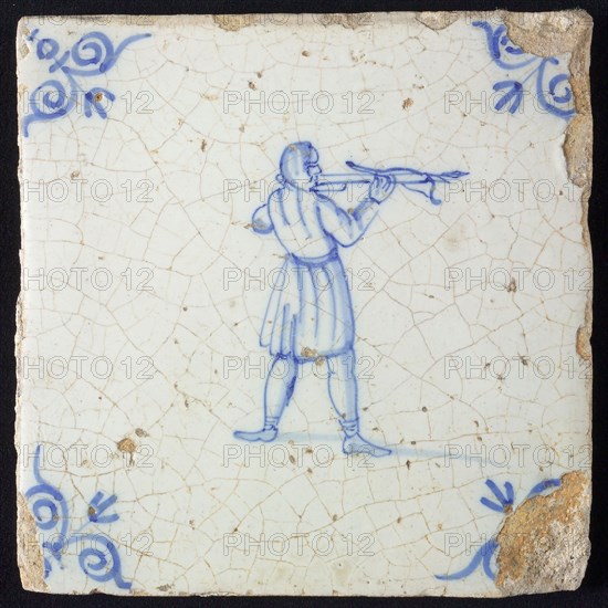 White tile with blue warrior with bow and arrow; corner pattern ox head, wall tile tile sculpture ceramic earthenware glaze