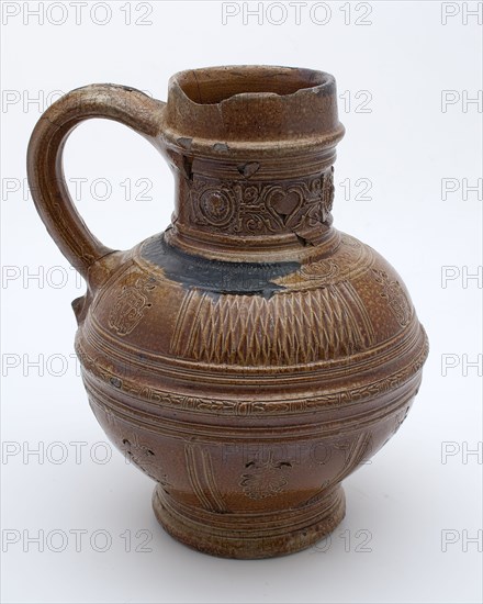 eter Knötgen (?), Brown stoneware jug, ear with tail, round neck frieze with circles and masks, hearts, signed, crockery holder